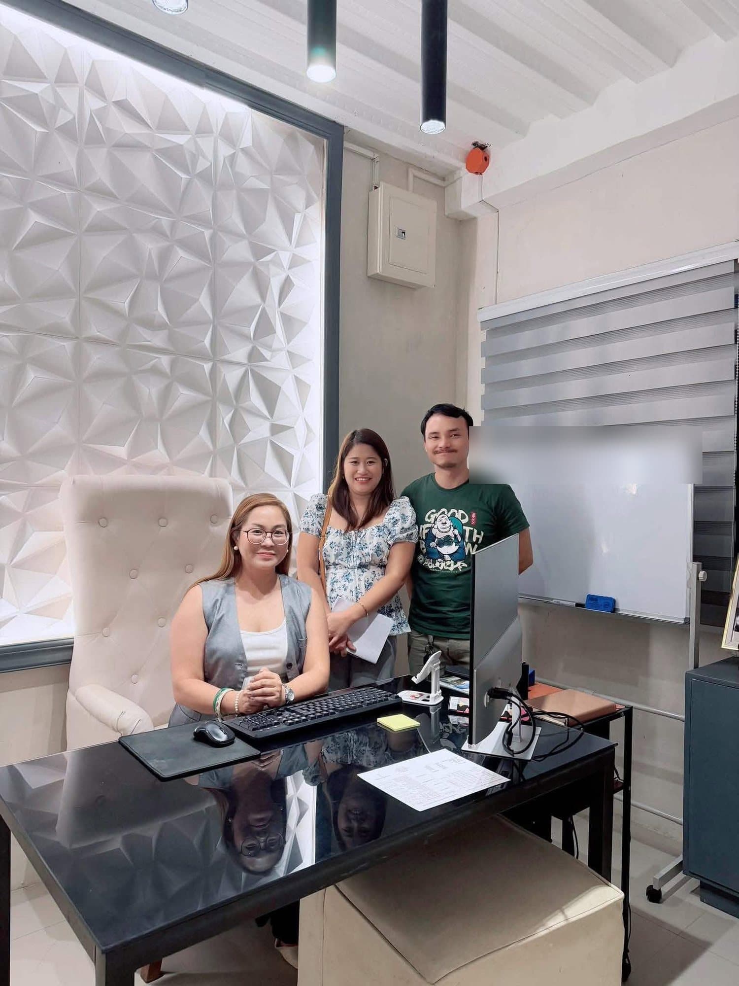 Sharon at her desk with a couple during a planning meeting at the Ever After office